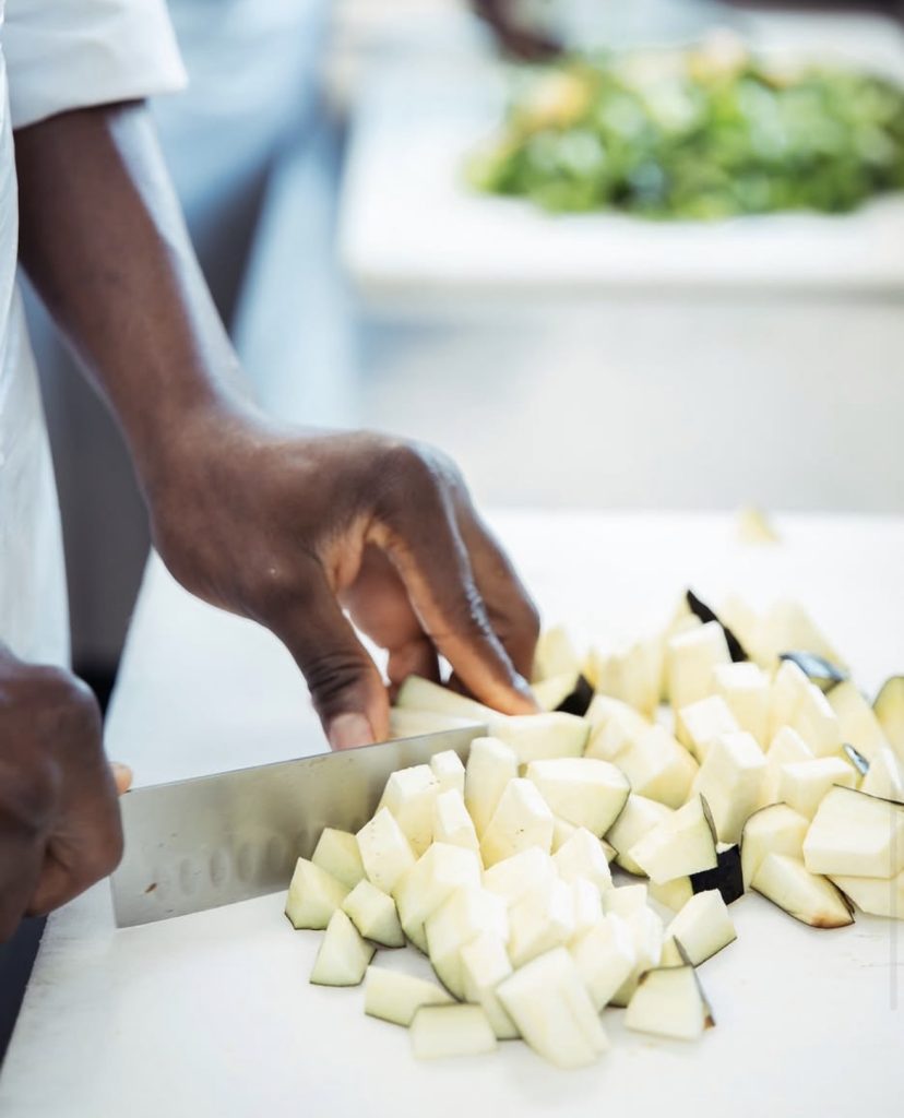 Préparation de légumes frais par un salarié en insertion.